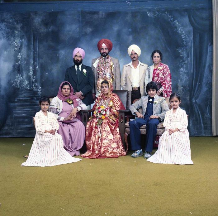 [Group photo of Parm Cheema and Swaren Dhaliwal with wedding guests]