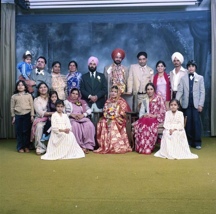 [Group photo of Parm Cheema and Swaren Dhaliwal with wedding guests]