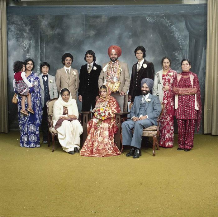 [Group photo of Parm Cheema and Swaren Dhaliwal with wedding guests]