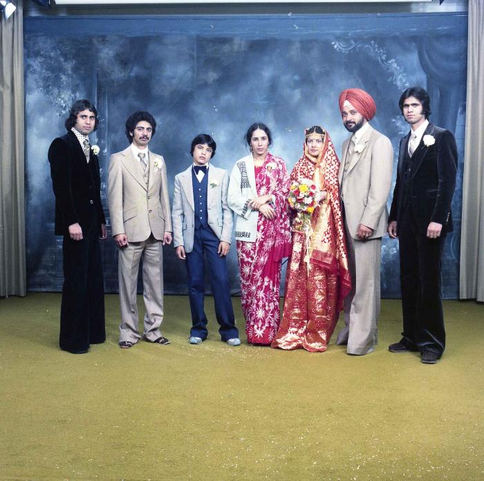 [Group photo of Parm Cheema and Swaren Dhaliwal with wedding guests]