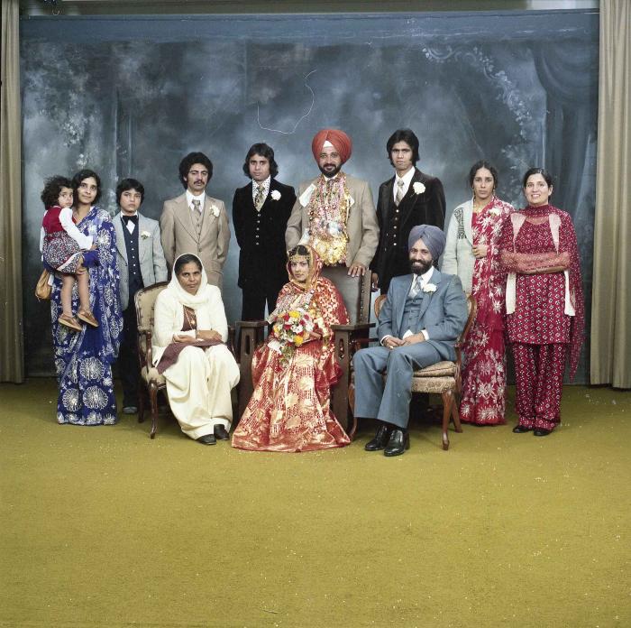 [Group photo of Parm Cheema and Swaren Dhaliwal with wedding guests]