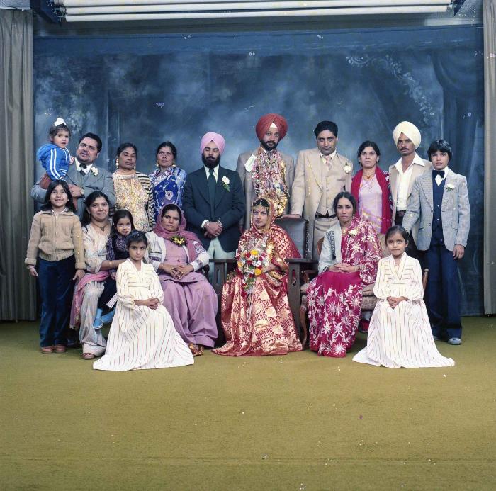 [Group photo of Parm Cheema and Swaren Dhaliwal with wedding guests]