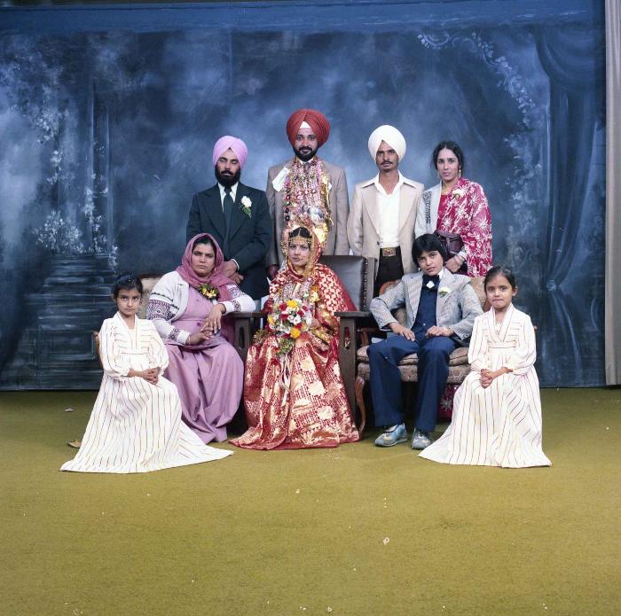 [Group photo of Parm Cheema and Swaren Dhaliwal with wedding guests]