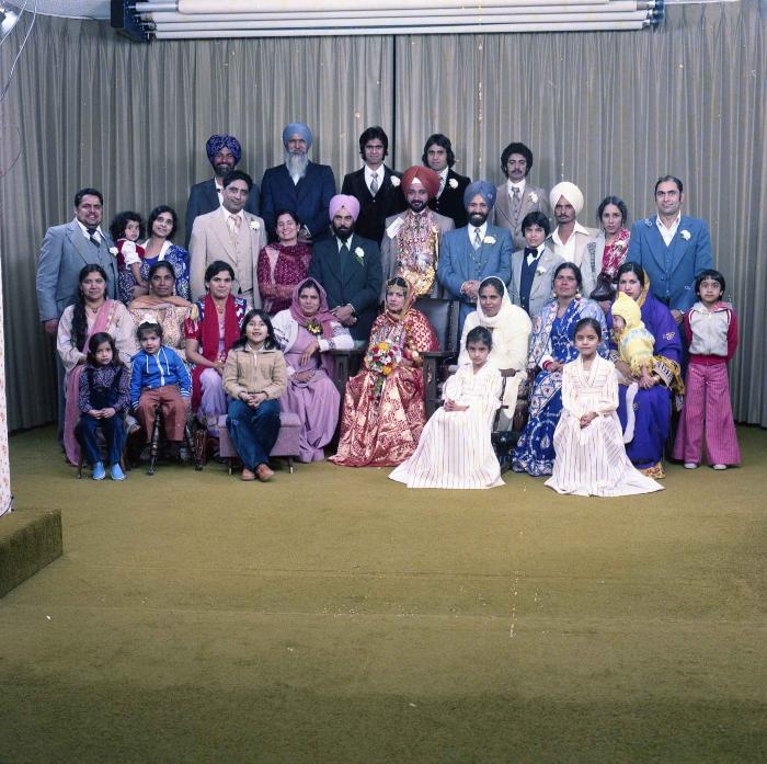 [Group photo of Parm Cheema and Swaren Dhaliwal with wedding guests]
