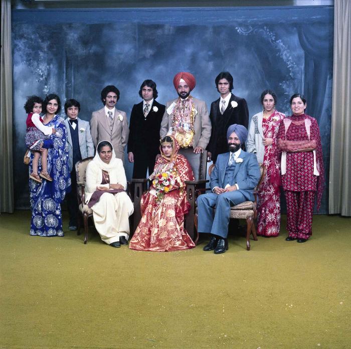 [Group photo of Parm Cheema and Swaren Dhaliwal with wedding guests]