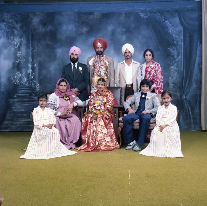 [Group photo of Parm Cheema and Swaren Dhaliwal with wedding guests]