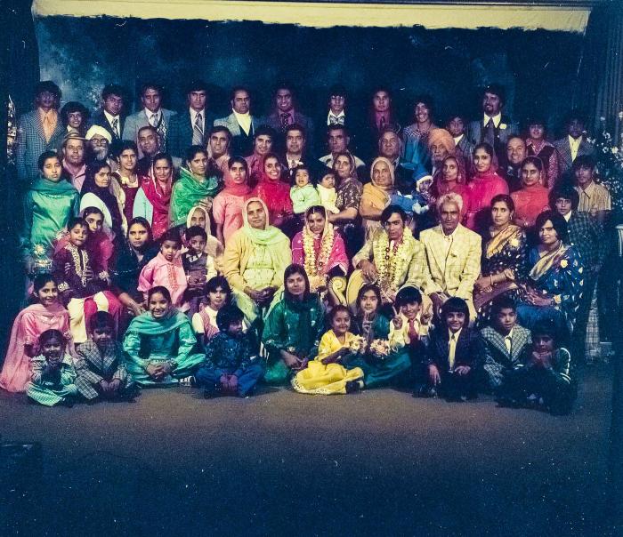 [Group photo of Kehar S. Cheema and unidentified bride with wedding guests at Gur Sikh Temple]