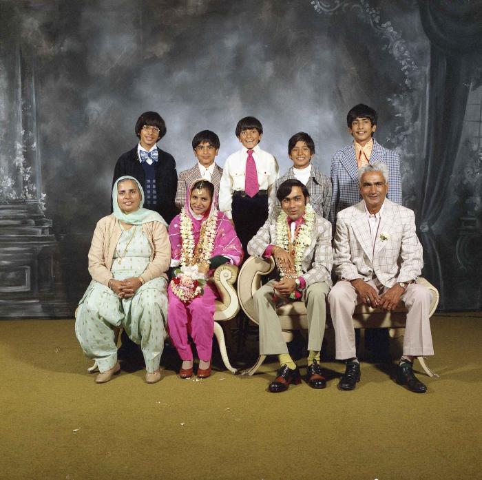 [Group photo of Kehar S. Cheema and unidentified bride with wedding guests]