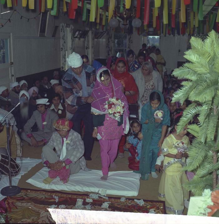 [Group photo of Kehar S. Cheema and unidentified bride with wedding guests]