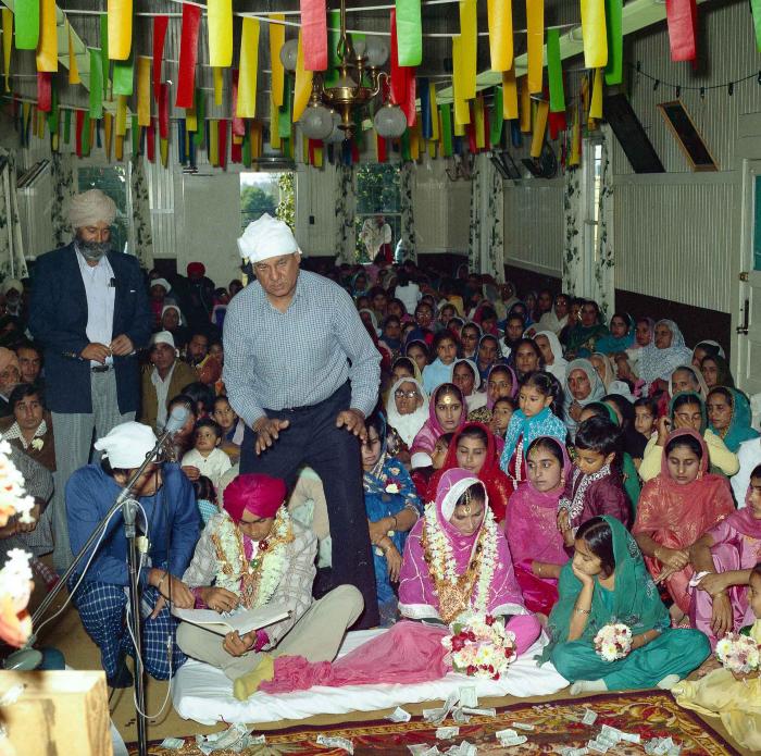 [Group photo of Kehar S. Cheema and unidentified bride with wedding guests]