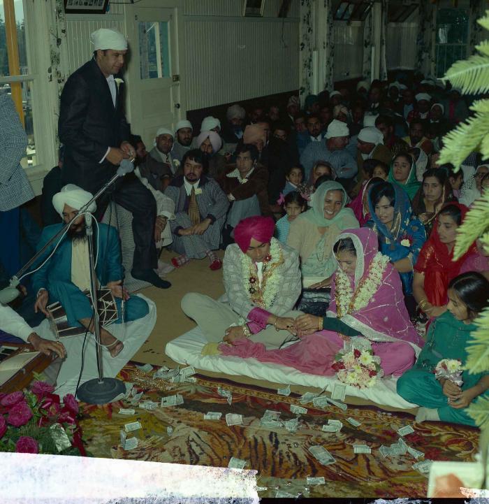 [Group photo of Kehar S. Cheema and unidentified bride with wedding guests]