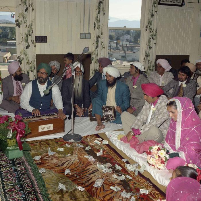 [Group photo of Kehar S. Cheema and unidentified bride with wedding guests]