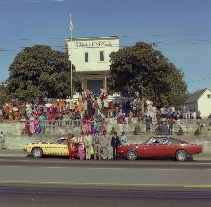 [Group photo of Kehar S. Cheema and unidentified bride with wedding guests outside Gur Sikh Temple]
