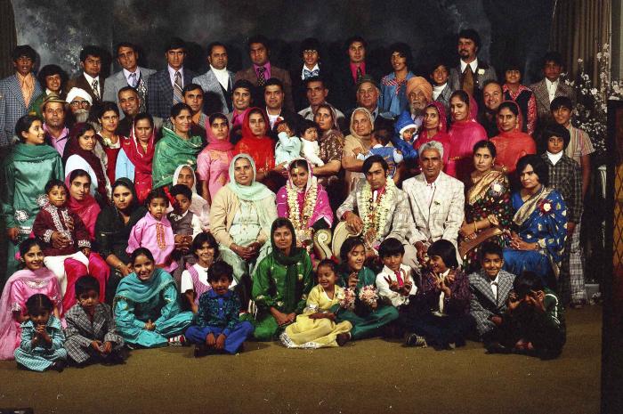 [Group photo of Kehar S. Cheema and unidentified bride with wedding guests]