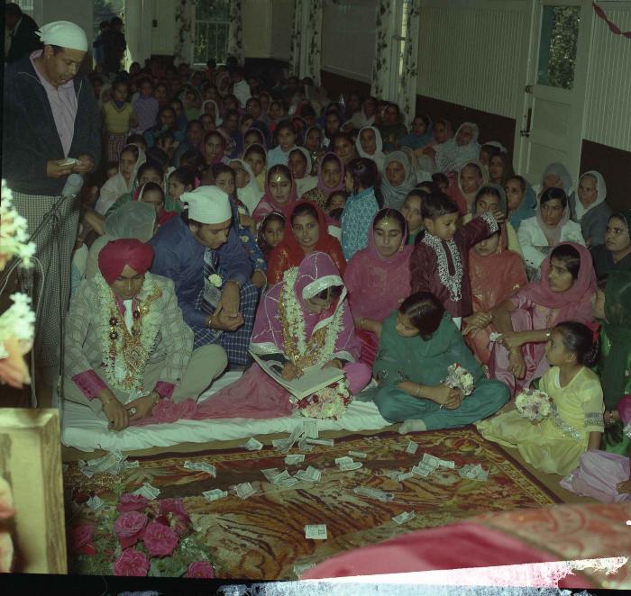 [Group photo of Kehar S. Cheema and unidentified bride with wedding guests]