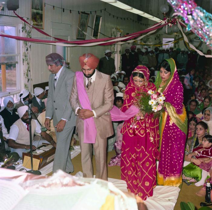 [Group photo of Jagpal Davinder and Manjit Sarowa with wedding guests]