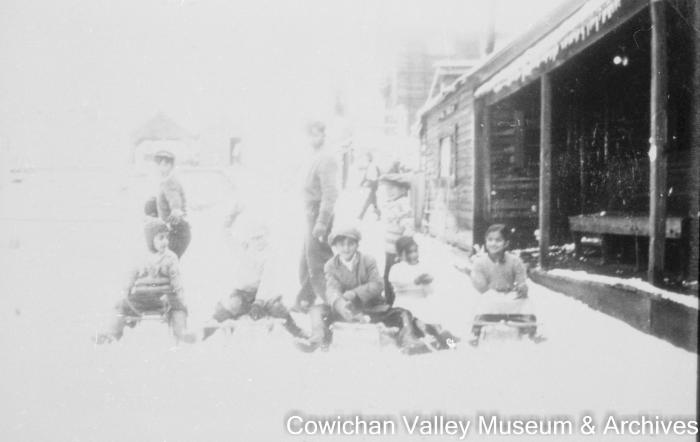 [Seven unidentified children playing in the snow]