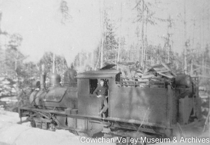 [Unidentified man standing in a locomotive]