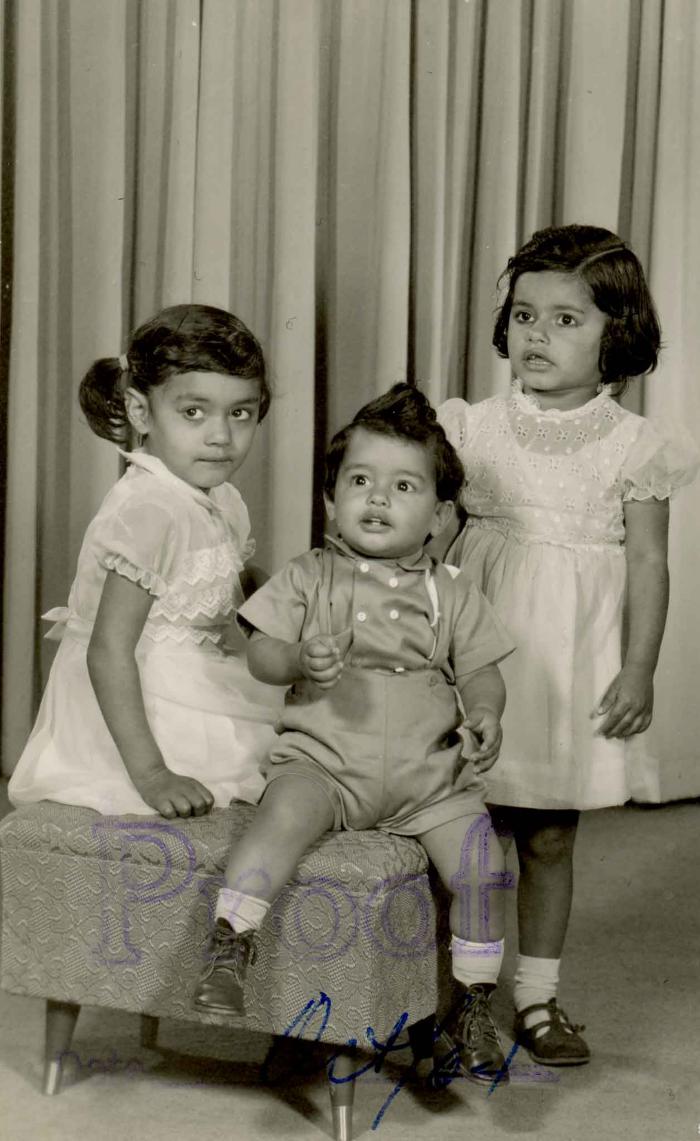 [Photo of three children]
