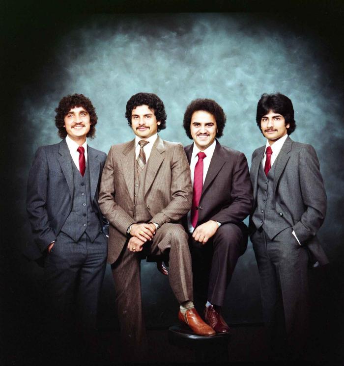 [Group photo of Gurmukh Gill with unidentified men]