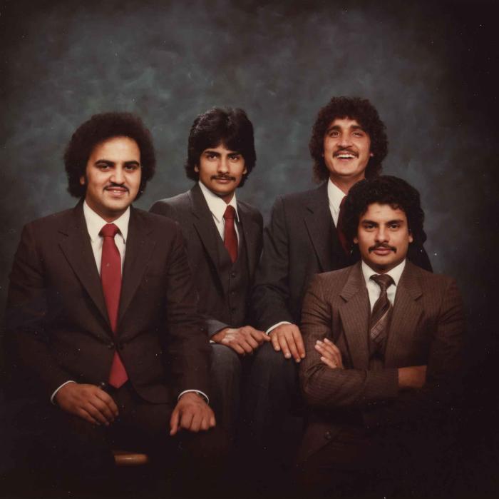 [Group photo of Gurmukh Gill with unidentified men]