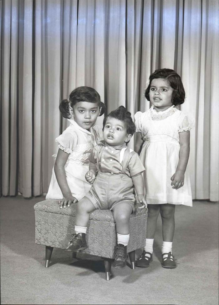 [Photo of three children]