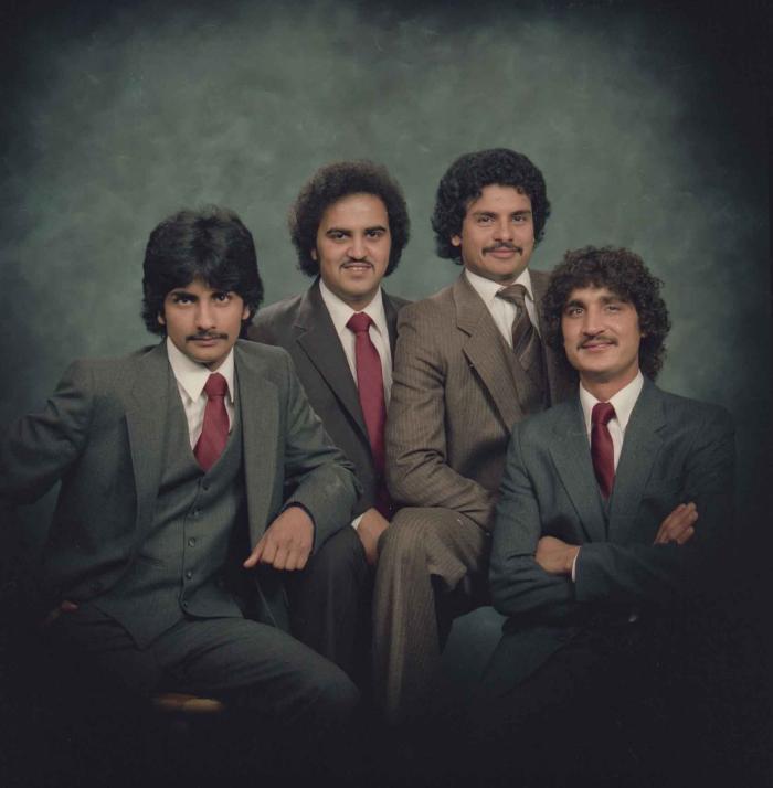 [Group photo of Gurmukh Gill with unidentified men]