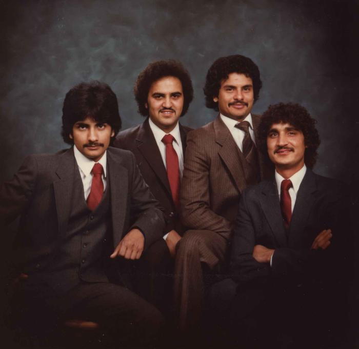 [Group photo of Gurmukh Gill with unidentified men]
