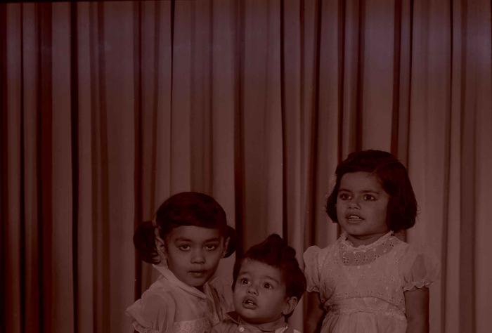 [Photo of three children]