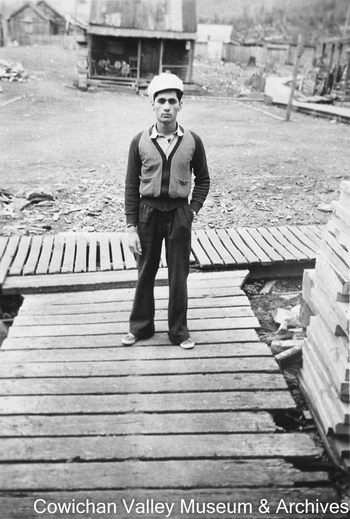 [Unidentified man standing on boardwalk]
