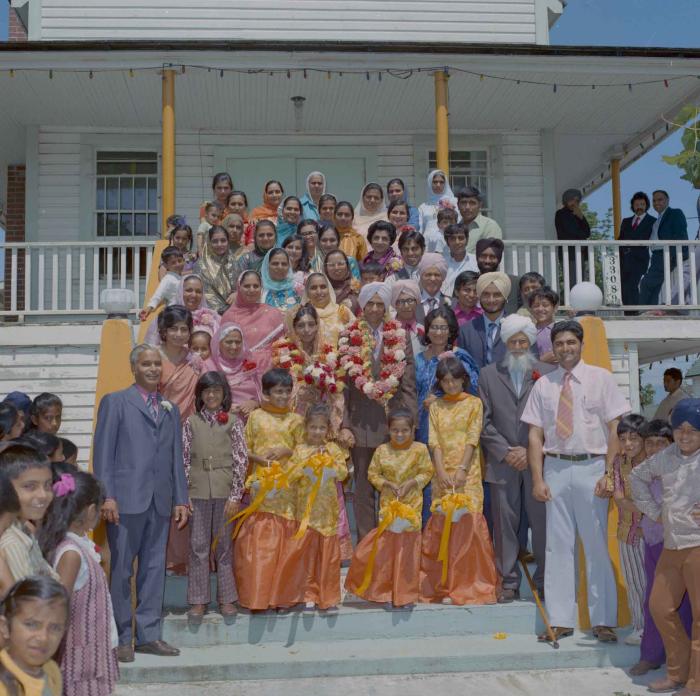 [Group photo of Rajinder Thind, Nash Gill and their families]