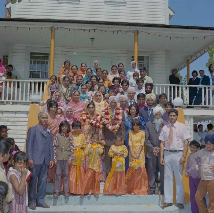 [Group photo of Rajinder Thind, Nash Gill and their families]