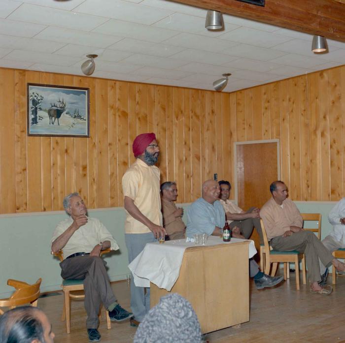 [Photo of Indar Singh Gill with a group of unidentified men]