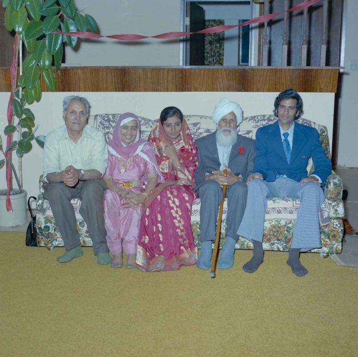 [Group photo of Rajinder Thind and Nash Gill with his family]