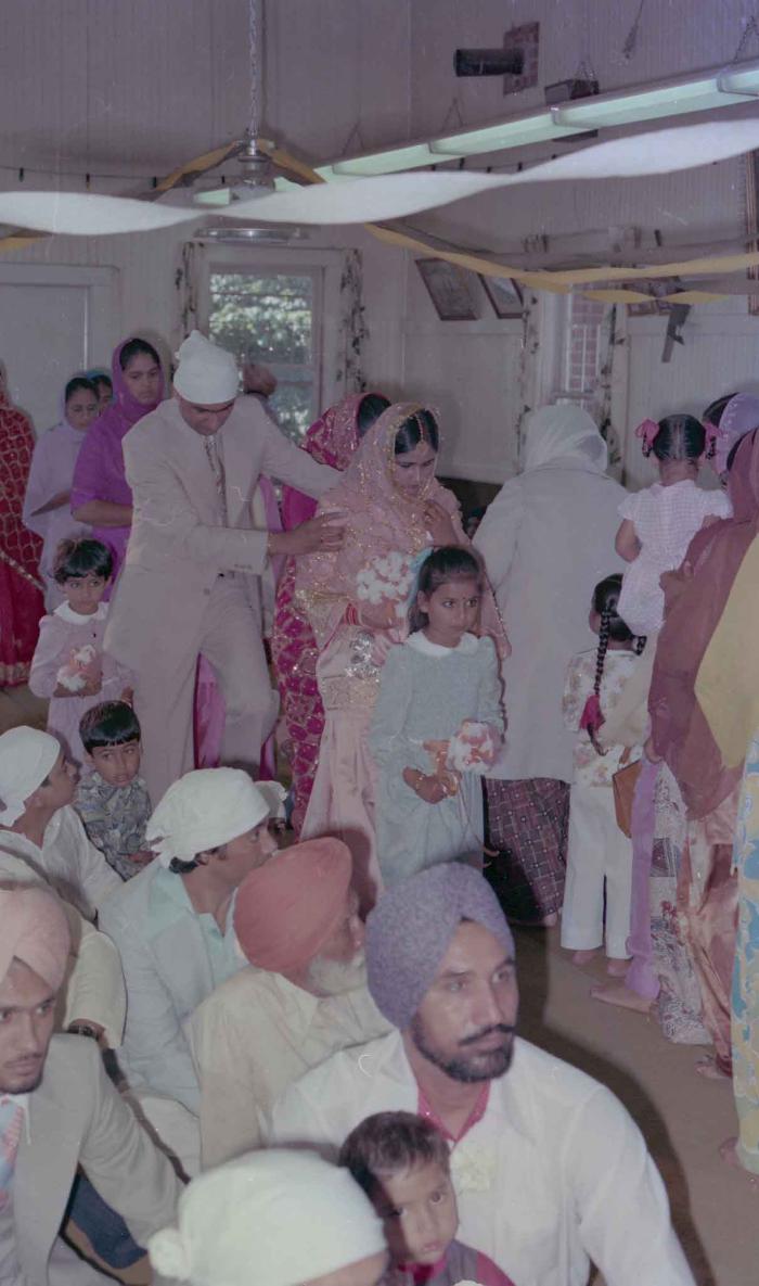 [Photo of Rupinder Toor with family entering the gurdwara]