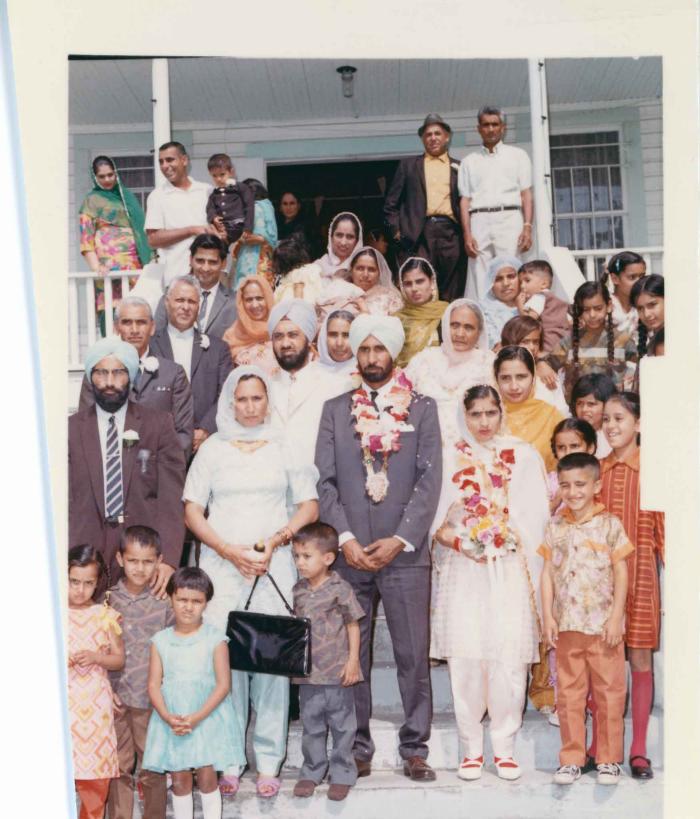 [Group photo of Gurmail Singh Sidhu with his wife and family members]