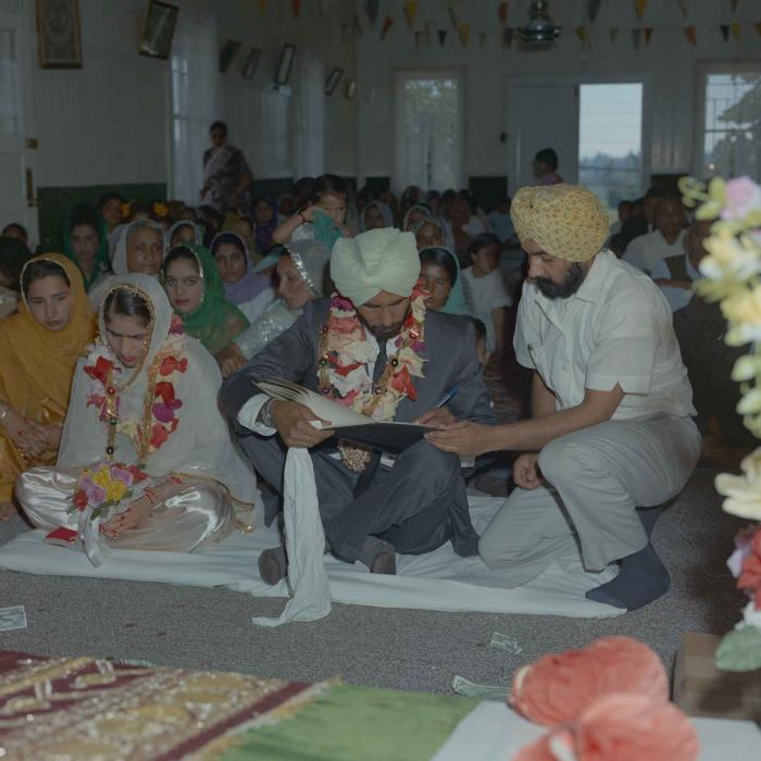 [Photo of Gurmail Singh Sidhu and his wife]