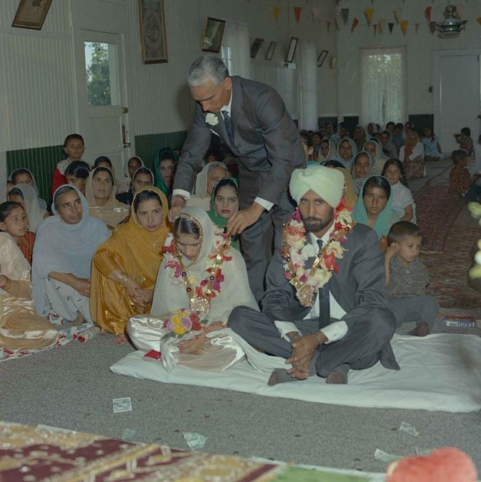 [Photo of Gurmail Singh Sidhu and his wife]