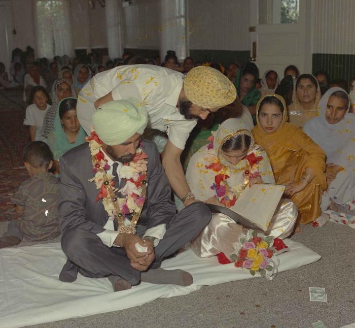 [Photo of Gurmail Singh Sidhu with wife]