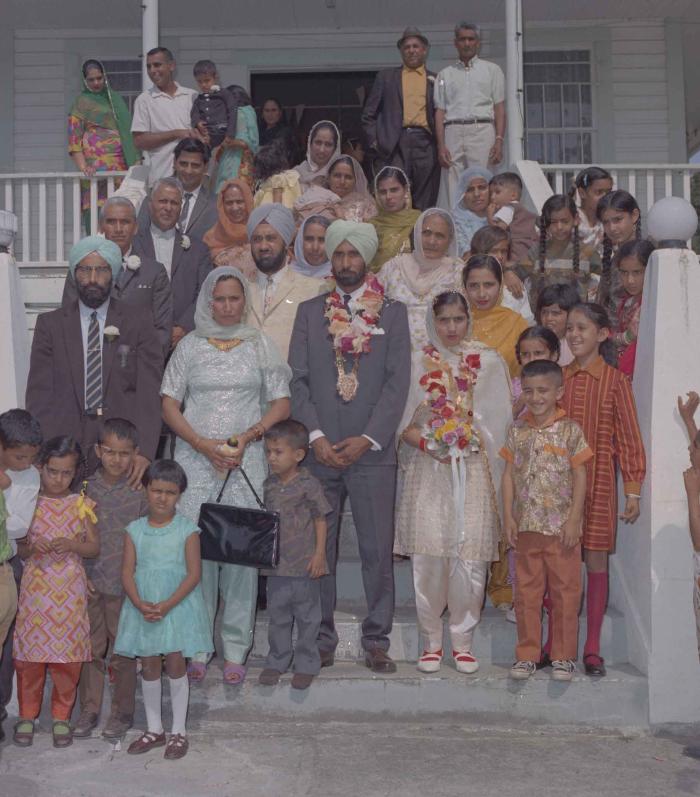 [Group photo of Gurmail Singh Sidhu with family members]