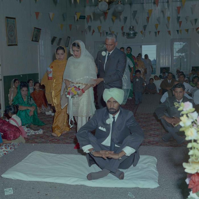 [Photo of Gurmail Singh Sidhu and his wife]