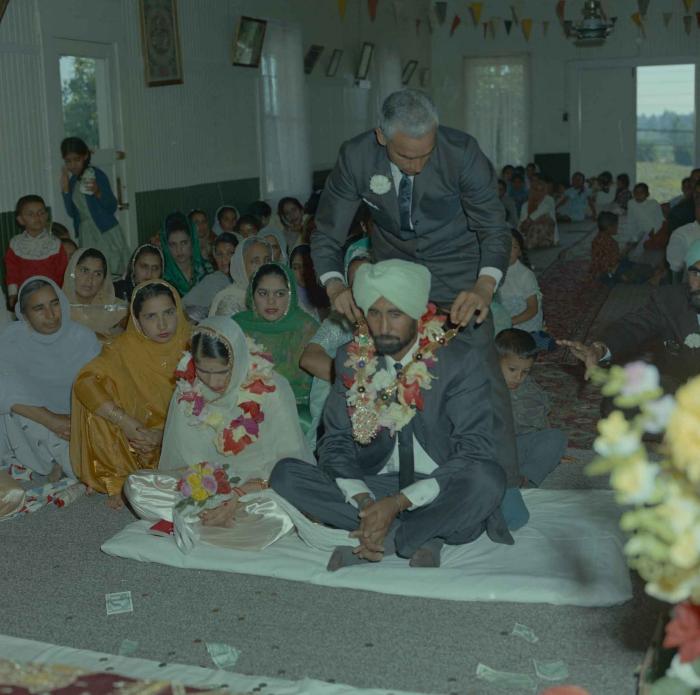 [Photo of Gurmail Singh Sidhu and his wife]