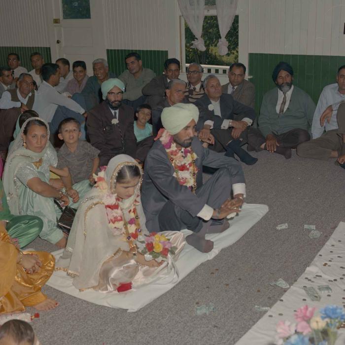 [Photo of Gurmail Singh Sidhu and his wife]