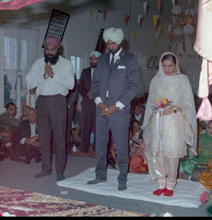 [Photo of Gurmail Singh Sidhu and his wife]