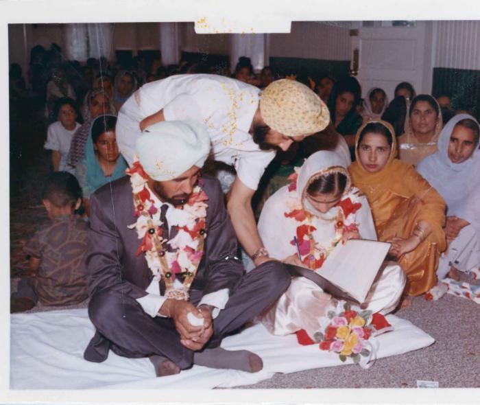 [Photo of Gurmail Singh Sidhu and his wife]