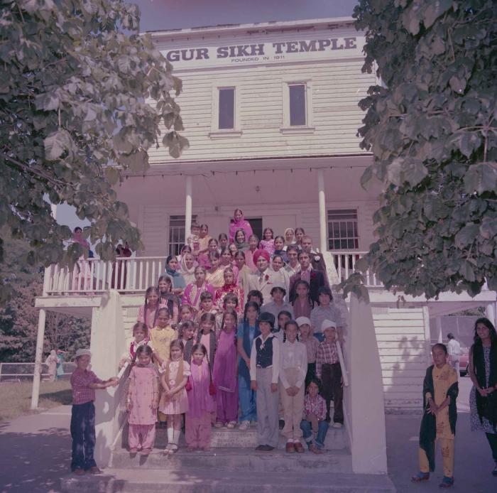[Group photo of Sinder Brar and Ranjit Guron standing with wedding guests]