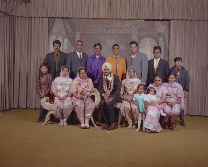[Group photo of Gurder Singh with and unidentified bride and wedding guests]