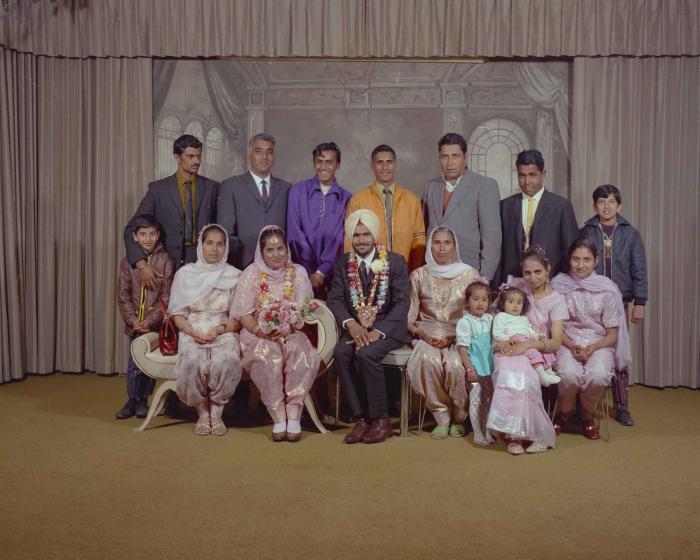 [Group photo of Gurder Singh with an unidentified bride and wedding guests]
