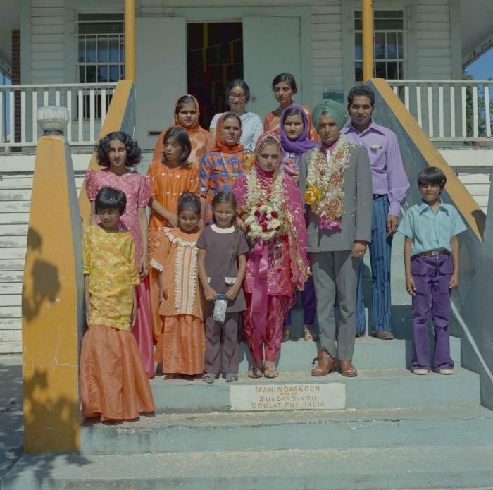 [Photo of Jaginder Singh Gill and Amarjit Gill with family members]