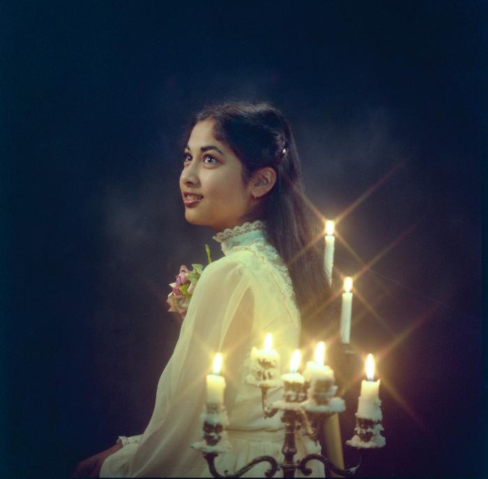 [Portrait of Kel Alamwala sitting near candelabra]